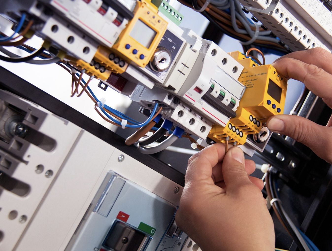 Technician wiring an electrical control panel