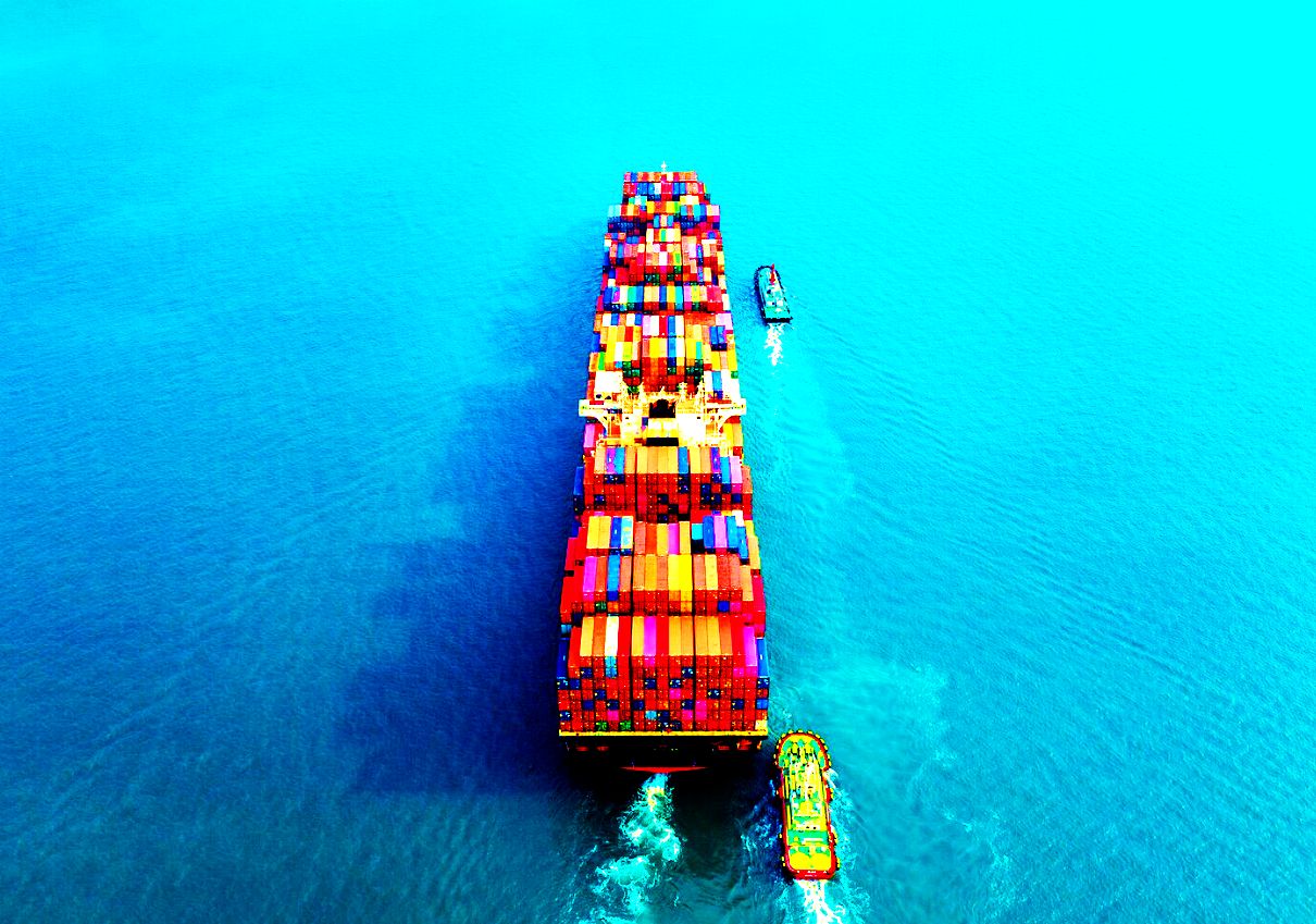 Container vessel seen from above in clear water